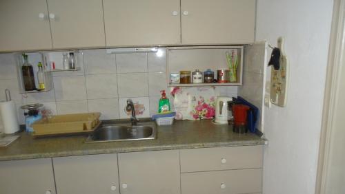 a kitchen with a sink and a counter top at Blue Dreams in Almiropótamos