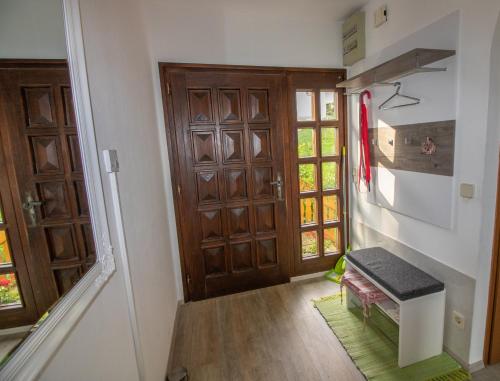 a hallway with a door and a bench in a room at Ernas Ferienhaus in Aschbach bei Fürstenfeld