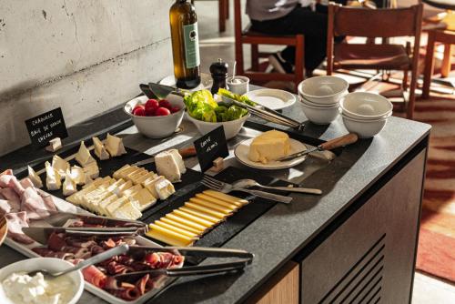a buffet with many different types of food on a table at voco Beaune , Cité des Vins by IHG in Beaune