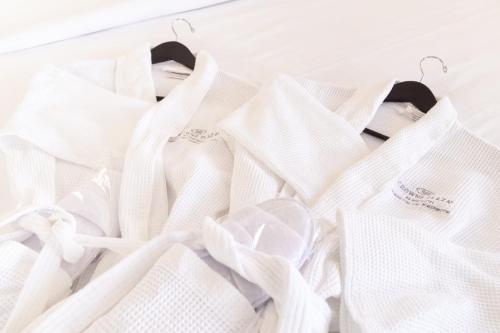a pile of white wedding dresses on hangers at Crowne Plaza Fredericton Lord Beaverbrook by IHG in Fredericton