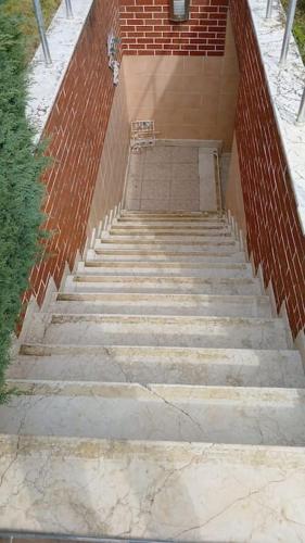 a set of stairs leading up to a brick wall at Villa Elegance in Kocaeli
