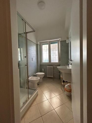 a bathroom with two toilets and a shower and a sink at Peppe's Bed in Rome