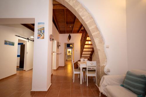a living room with a table and a dining room at Villa Irini in Kallithea Rhodes