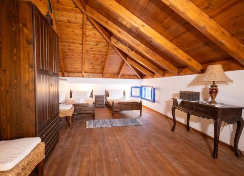 a living room with wooden ceilings and a table at Villa Irini in Kallithea Rhodes