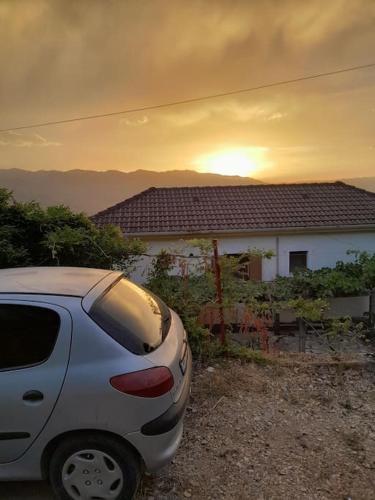 a white car parked in front of a house at Sara & Mateo Guesthouse in Libohovë