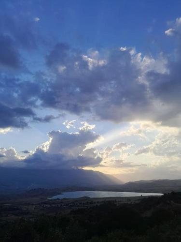 a cloudy sky with a view of a body of water at Sara & Mateo Guesthouse in Libohovë