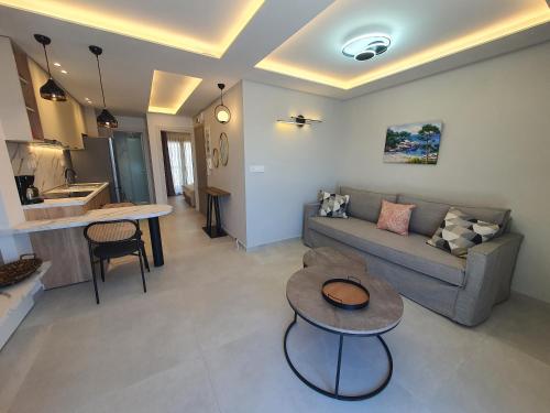 a living room with a couch and a table at Sealon Suite & Loft in Limenaria