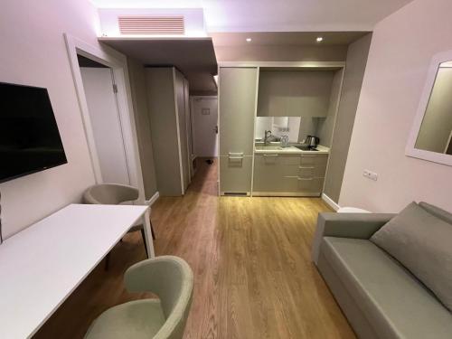 a living room with a couch and a table at PANORAMA Apartments BATUMI in Batumi