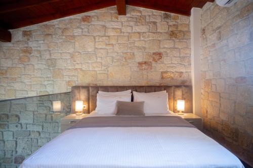 a bedroom with a large bed with two lamps at Villa Palma in Kallithea Halkidikis