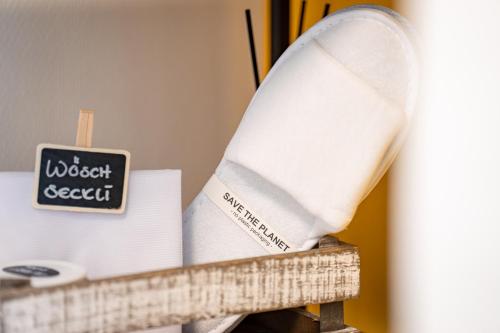 a piece of paper sitting on a shelf with a sign at B&B Bellagio Davos in Davos