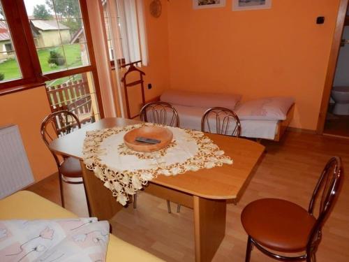 a dining room with a table and chairs with beds at Ubytovanie u Ladislava in Vrbov