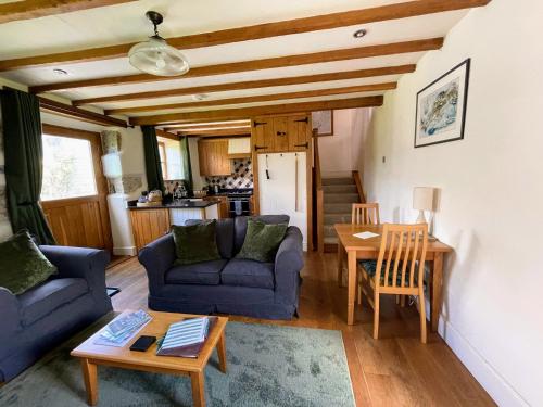 a living room with a couch and a table at Widecombe Cottage in Widecombe in the Moor