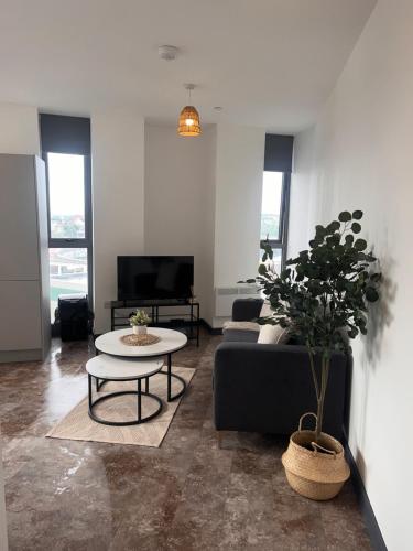 a living room with a couch and a table at Highpoint in Bradford