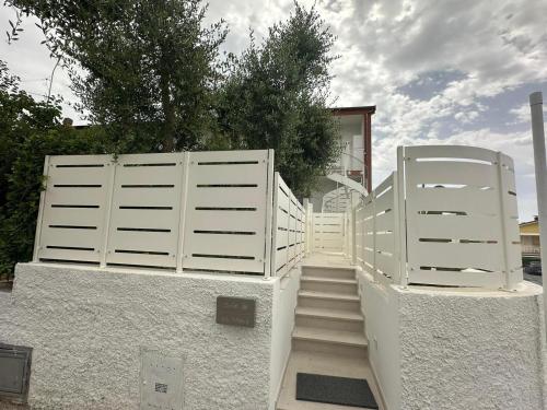 a set of white gates in front of a house at Appartamento Mare in Numana