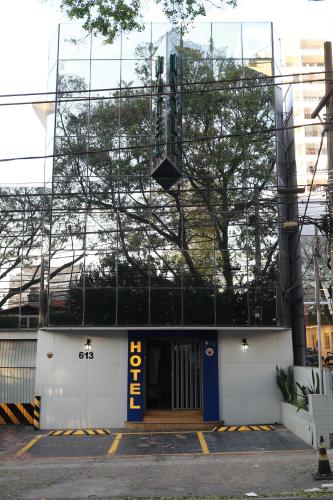 a building with a blue and yellow sign on it at Hotel Mooca in Sao Paulo