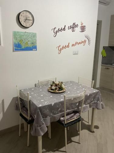 a dining room table with a good life good morning sign on a wall at Casa 700 in Civitavecchia