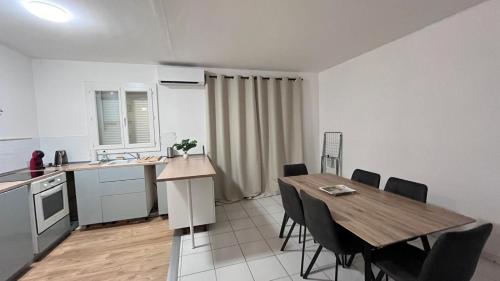 a kitchen and dining room with a table and chairs at Appartement climatisé avec parking à Albi in Albi