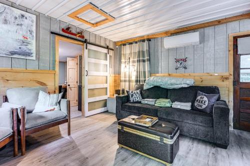 a living room with a couch and a table at Lake Access and Kayaks Gladwin Cottage Near Golfing in Gladwin