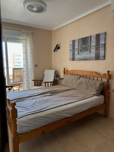 a bedroom with a bed with a wooden frame at Torrevieja - LaMata - Sonny in La Mata
