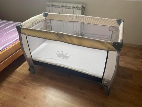 a bed with a crib in a room with a bedskirtspectspectspectspects at Seosko turističko domaćinstvo Tisa i Begej in Kni°anin