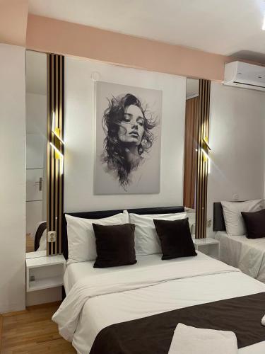 a bedroom with two beds and a drawing on the wall at Petreski Apartments 1 in Ohrid