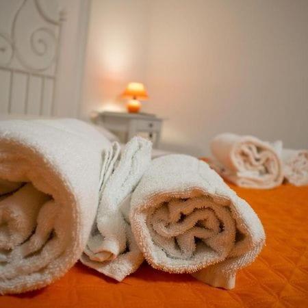 a pile of towels on top of a bed at Domus Lord Byron in Formia
