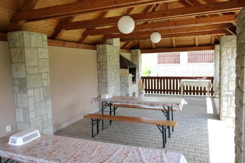 a patio with a wooden table and a bench at Penzion Chalupka II in Spišské Podhradie