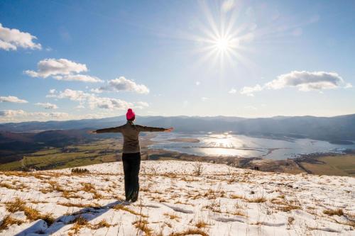 a person standing on top of a hill with their arms outstretched at House Mavko Near Lake Cerknica - Happy Rentals in Grahovo
