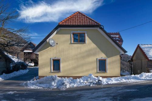 a house with a red roof in the snow at Farmhouse Raspberry Pool&Wellness - Happy Rentals in Vransko