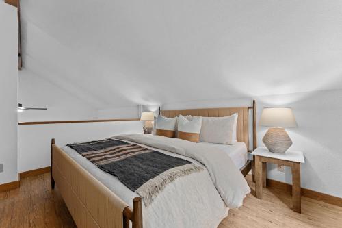 a bedroom with a bed and a table and a lamp at The Wagen Haus, fireplace and hot tub! in Fredericksburg