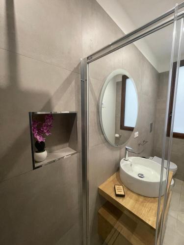 a bathroom with a sink and a mirror at Olea in Castelluzzo