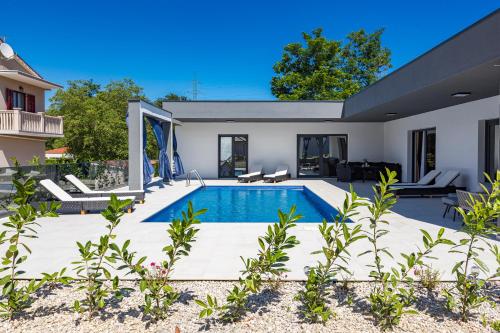 a swimming pool in the backyard of a house at Pool House Fancy - Happy Rentals in Labin