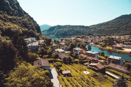 an aerial view of a small town next to a river at Villa Anita - Happy Rentals in Caslano