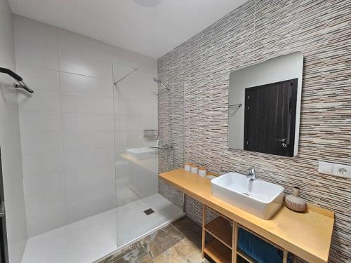a bathroom with a sink and a shower at Luna Azul in Playa Blanca