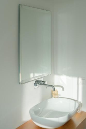 a bowl sink on a wooden counter with a mirror at San Giuseppe Relais in Maratea