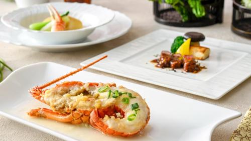 two plates of food on a table with shrimp at InterContinental Yokohama Grand by IHG in Yokohama