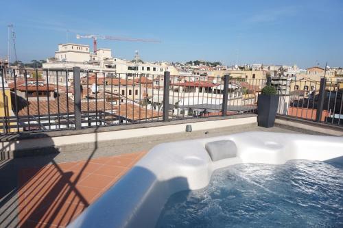 uma banheira de hidromassagem numa varanda com vista para a cidade em Trevi Palace Luxury Inn em Roma