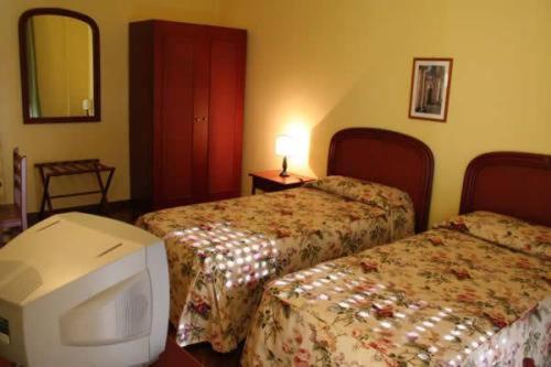 A bed or beds in a room at Hotel Morfeo Residence