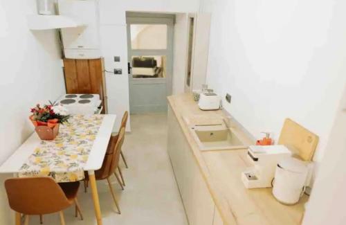 a small kitchen with a table and a dining room at Old town luxury segment in Braşov