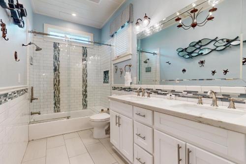 a bathroom with a tub sink and a toilet at The Salty Whale in Galveston