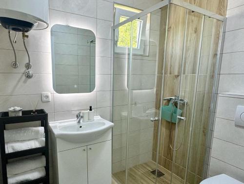 a bathroom with a shower and a sink at Apartmani Asovic in Budva