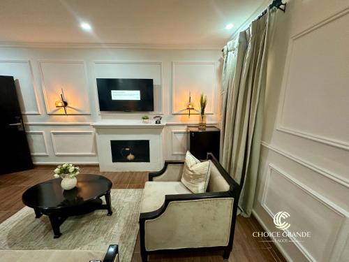 a living room with a fireplace and a tv at Choice Grande Lagos in Ikeja