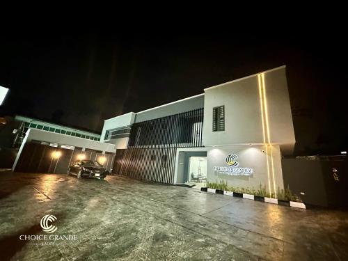 a building with a parking lot in front of it at night at Choice Grande Lagos in Ikeja