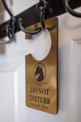 a do not disturb sign hanging on a door at The George & Dragon in Belper