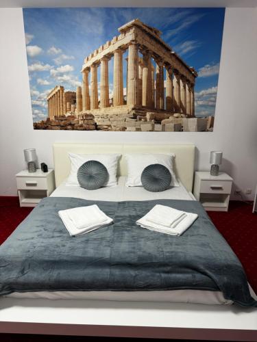 a bedroom with a large bed with a building in the background at Butik Hotel w centrum 350m od morza in Ustronie Morskie