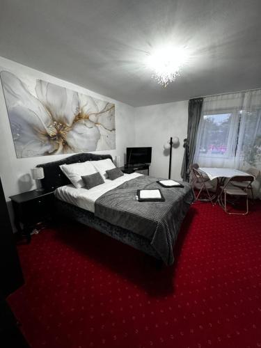 a bedroom with a large bed and a red carpet at Butik Hotel w centrum 350m od morza in Ustronie Morskie