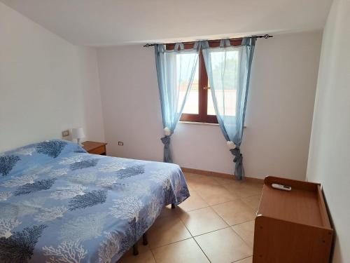 a bedroom with a bed and a window at Terrazza Michelino in Parghelia