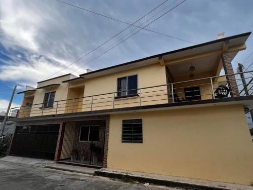a yellow building with a balcony on top of it at Casa Toledo Chetumal in Chetumal