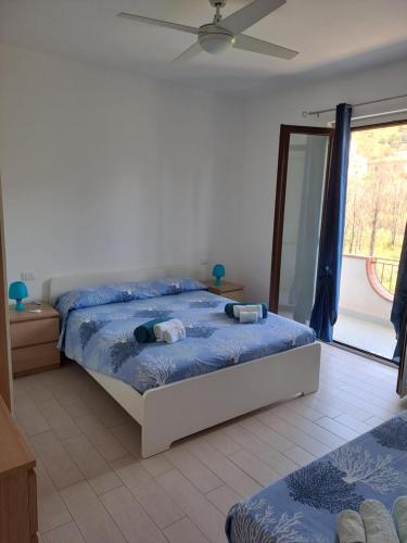 a bedroom with two beds and a ceiling fan at Terrazza Michelino in Parghelia