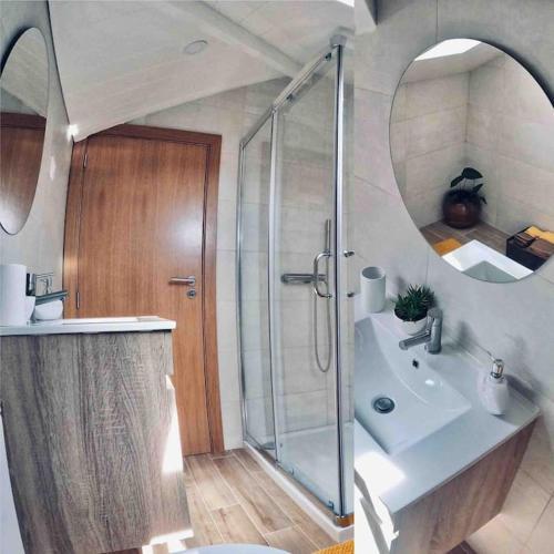 a bathroom with a shower and a sink and a mirror at Pure Mountain - Serra da Estrela in Erada